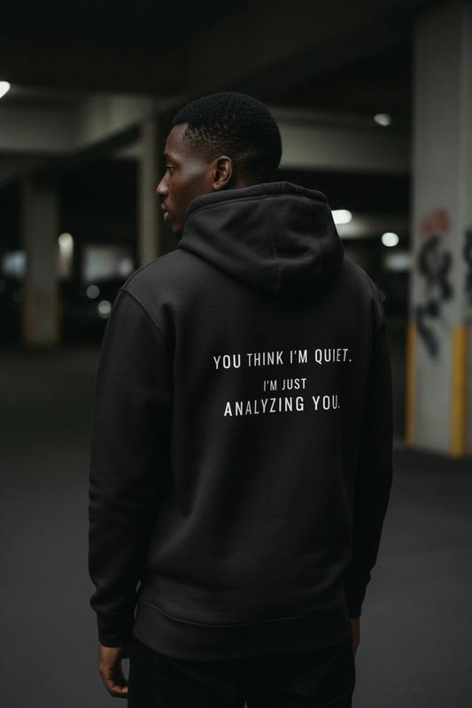 Black hoodie back view with statement text, minimal streetwear aesthetic,analysing mindset