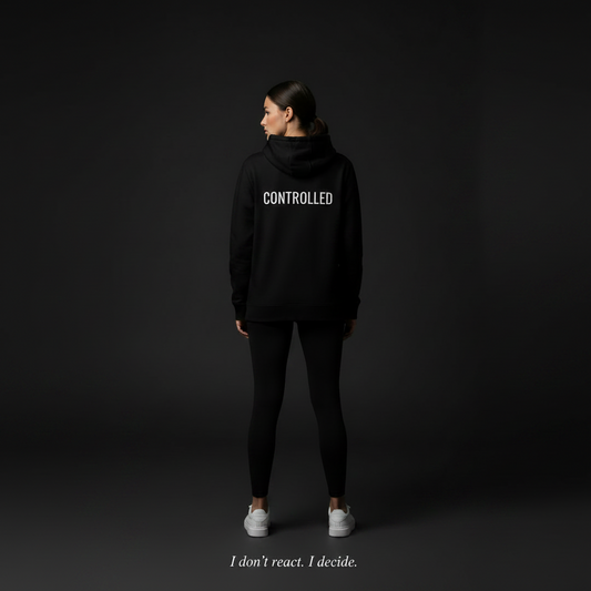 black minimalist hoodie with small chest text controlled streetwear for overthinkers and disciplined mindset