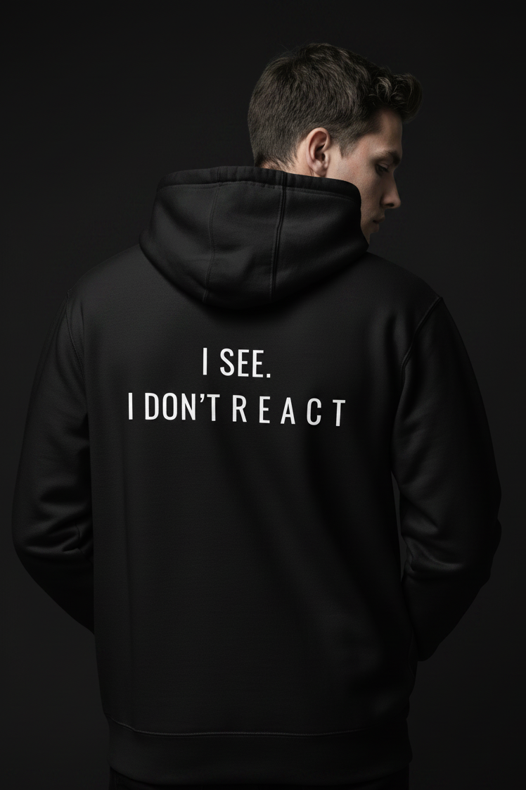 black minimalist hoodie with small chest text react streetwear for calm mindset and overthinkers