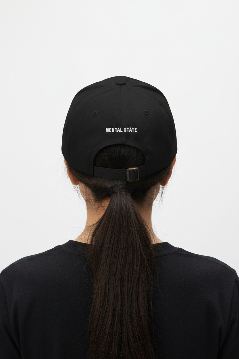 Back of black cap with adjustable strap.
Optional small text detail (MENTAL STATE