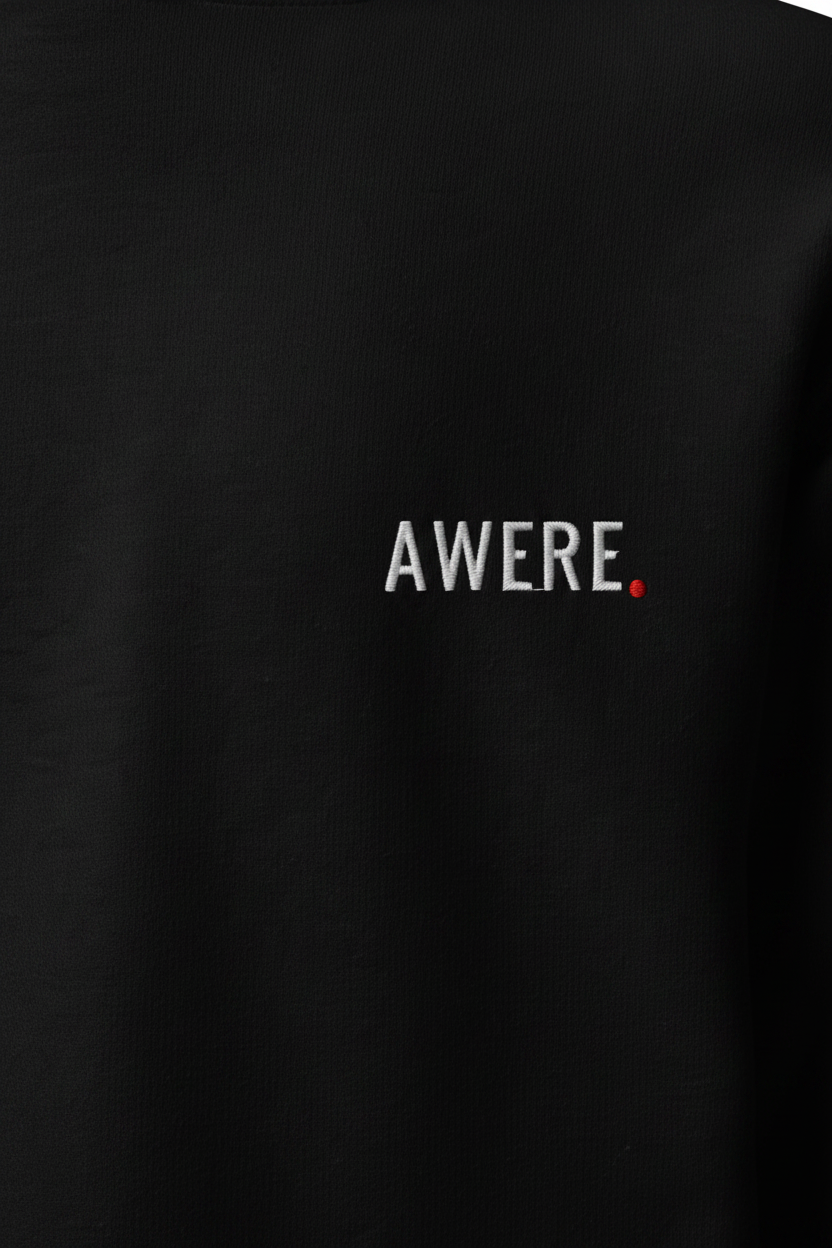 Close-up detail of premium black heavyweight AWARE hoodie with minimal chest logo