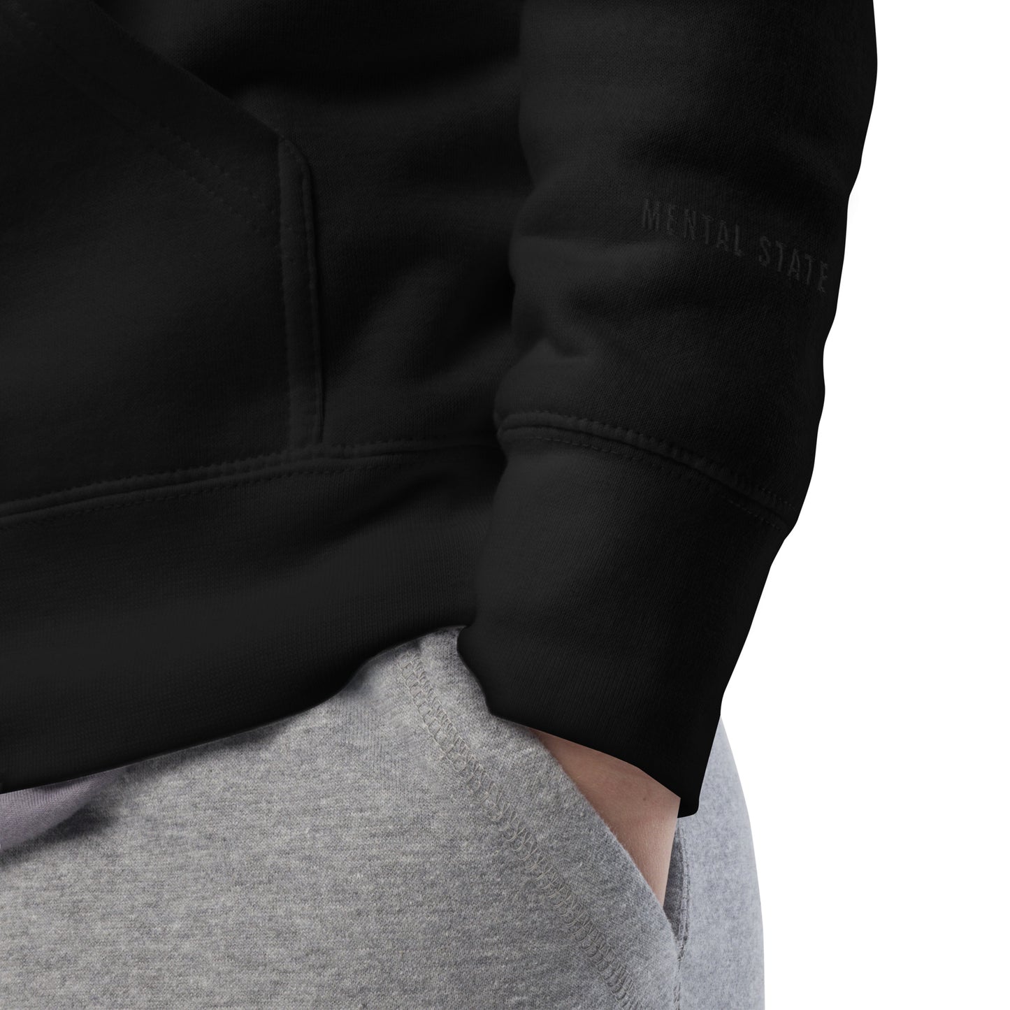 Close-up detail of premium black CONTROL hoodie showing Mental state logo heavyweight fabric texture