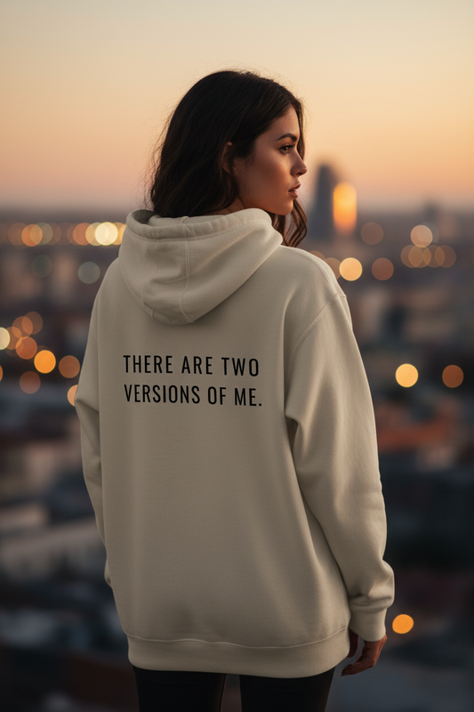 Mental State oversized beige hoodie with “There Are Two Versions Of Me” back print, minimalist luxury streetwear aesthetic, female model back view.